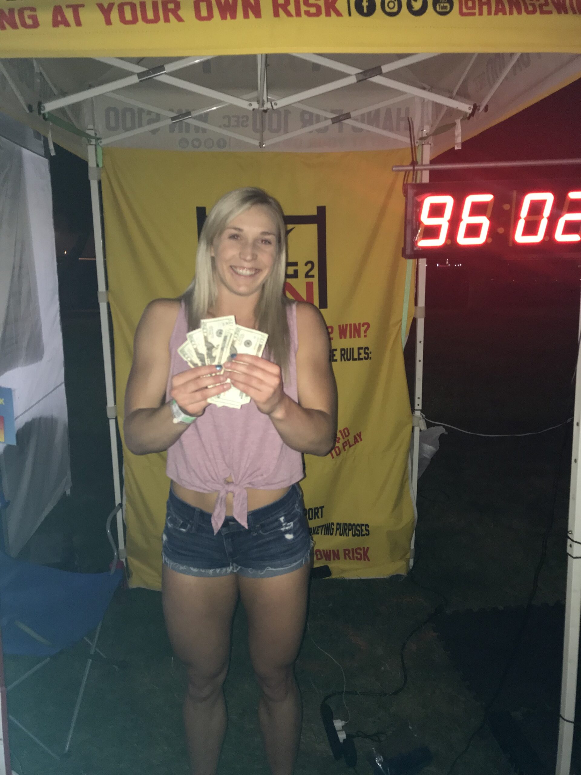 Female winner of the $100 rotating pull-up bar hang challenge